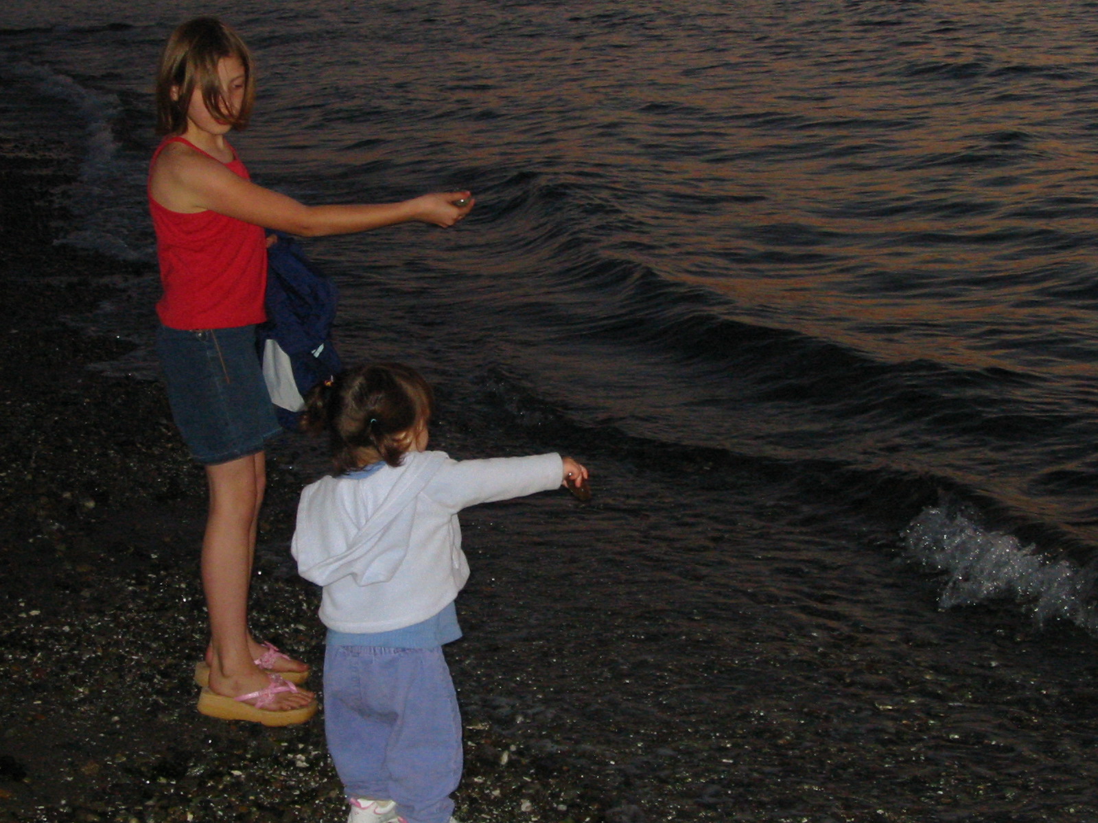 "There you go!" Morgan & Talia skipping stones at Carkeek. Wednesday 16 June 2004.